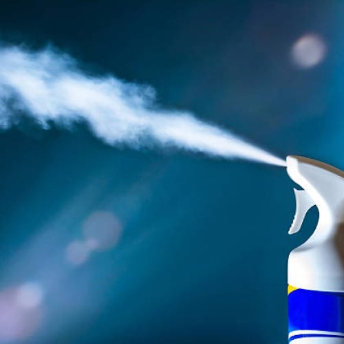 Air freshener spray aerosols in action in the light of sun